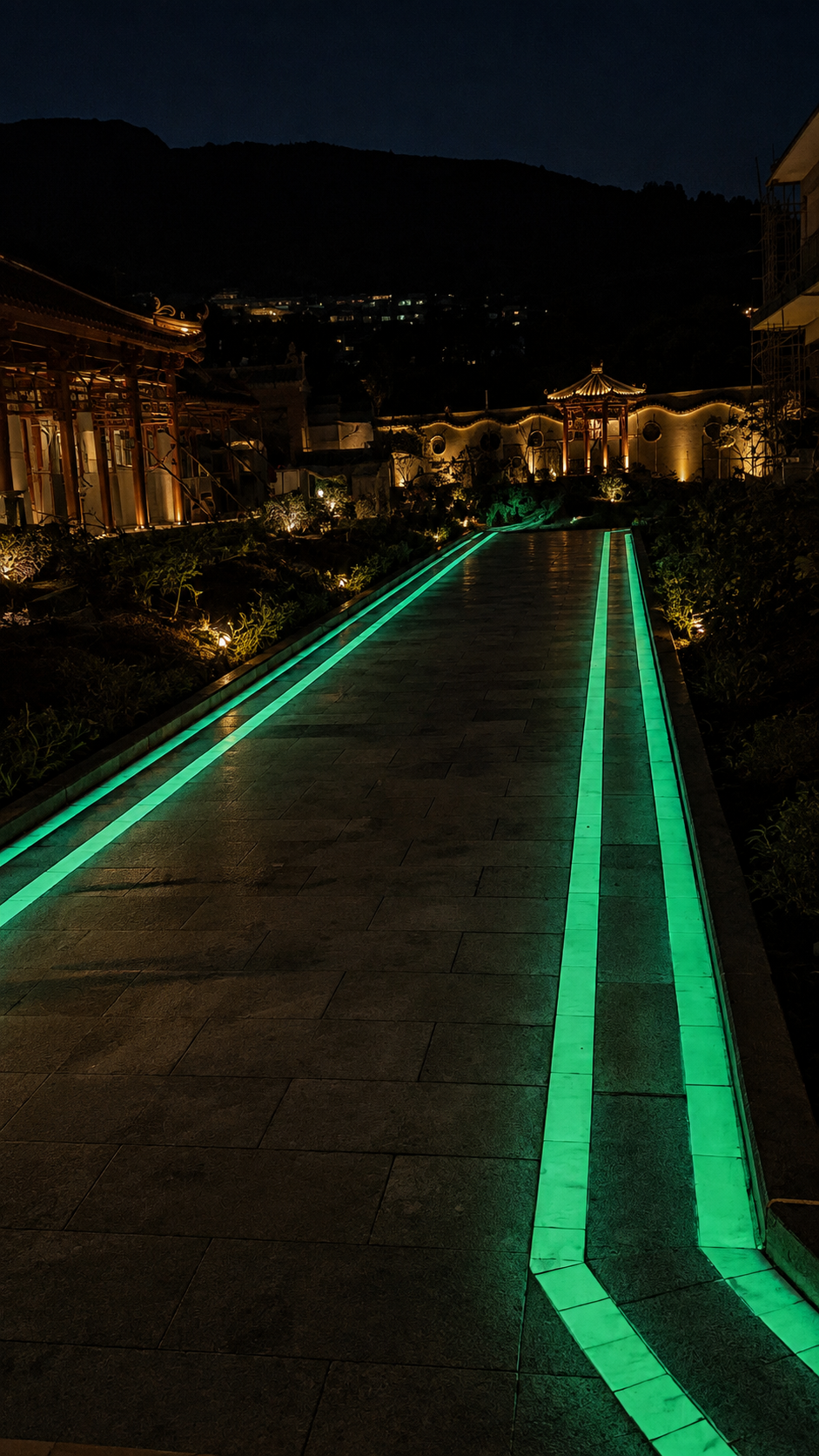 Glow in the dark pathway illuminated with green decorative lighting at night
