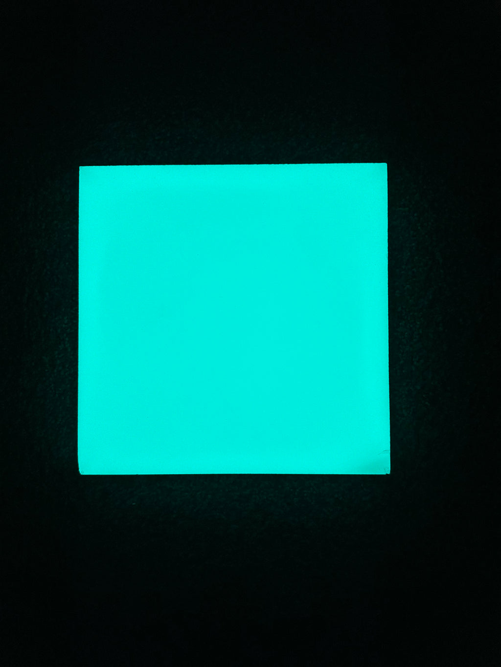Turquoise glowing ceramic tile square night view